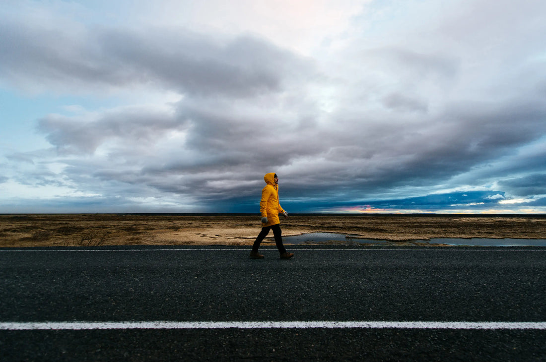 Man walking on remote road. 